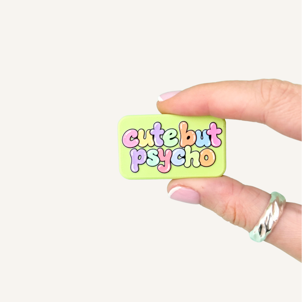 Cute But Psycho Pocket Magnets in lime green with colourful raised bubble lettering, a textured magnetic sensory fidget toy.
