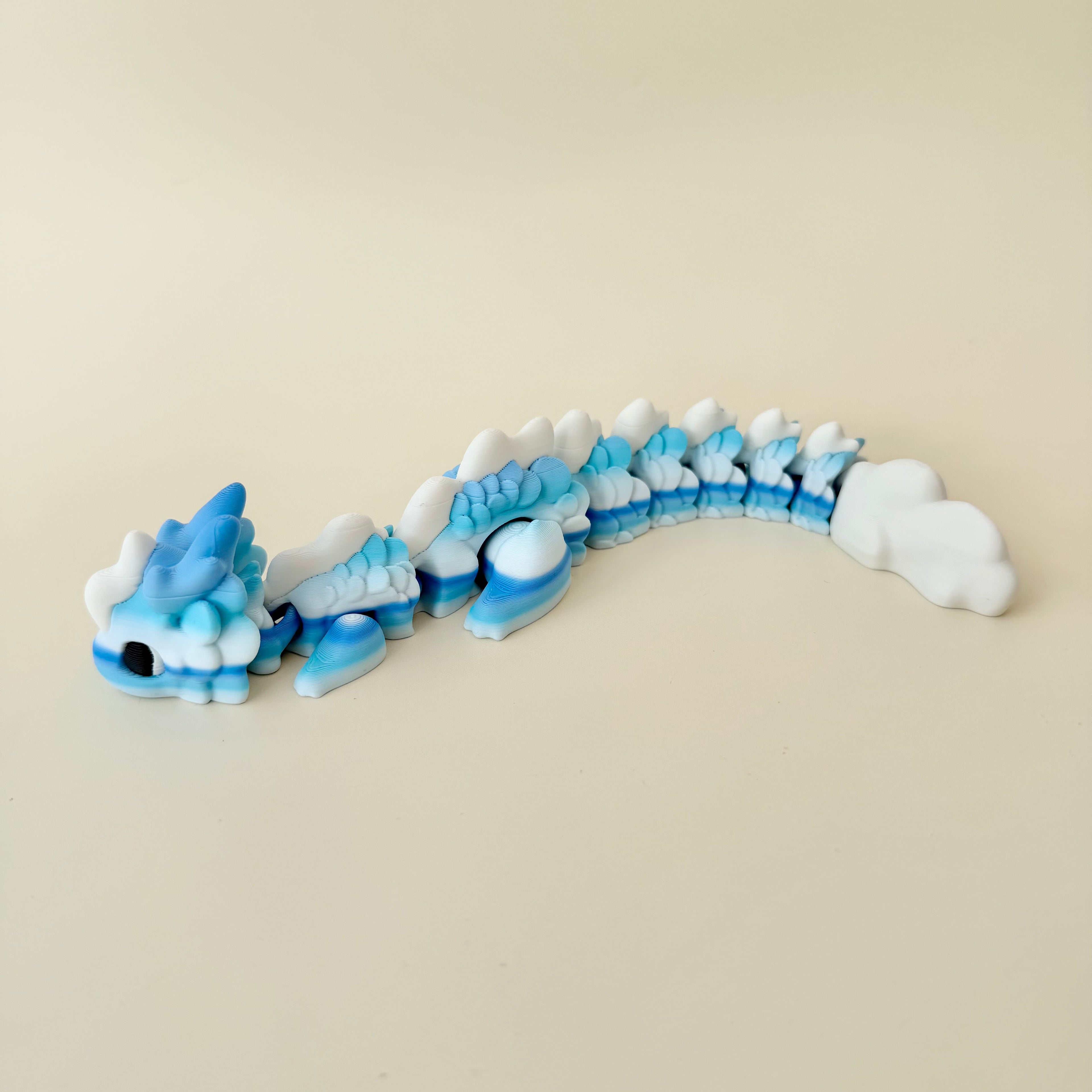 Raised scale texture for tracing plus flexible body; quiet non-click feedback; blue-to-white PLA dragon, 25 cm.