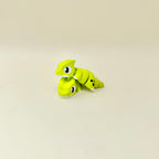 Bright green articulated dragon with repetitive movement for stimming, focus support and tactile input.