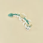 Dragon-style fidget toy with smooth segments and a subtle green and yellow gradient.