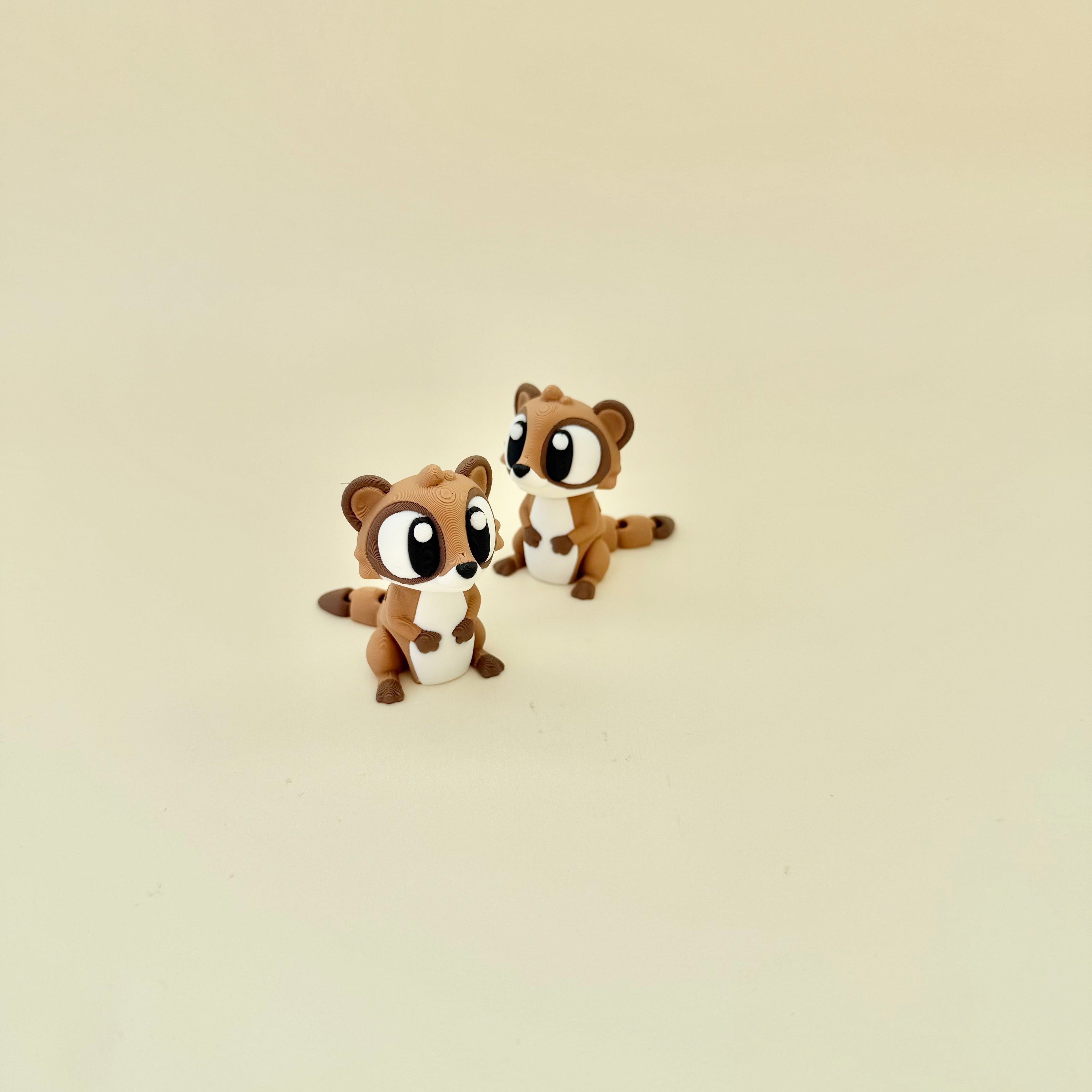 Small meerkat toy with moving head and tail for stimming, grounding and everyday fidgeting.
