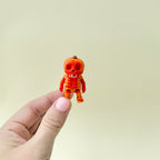 Miniature pumpkin-themed skeleton with detailed joints and textured design
