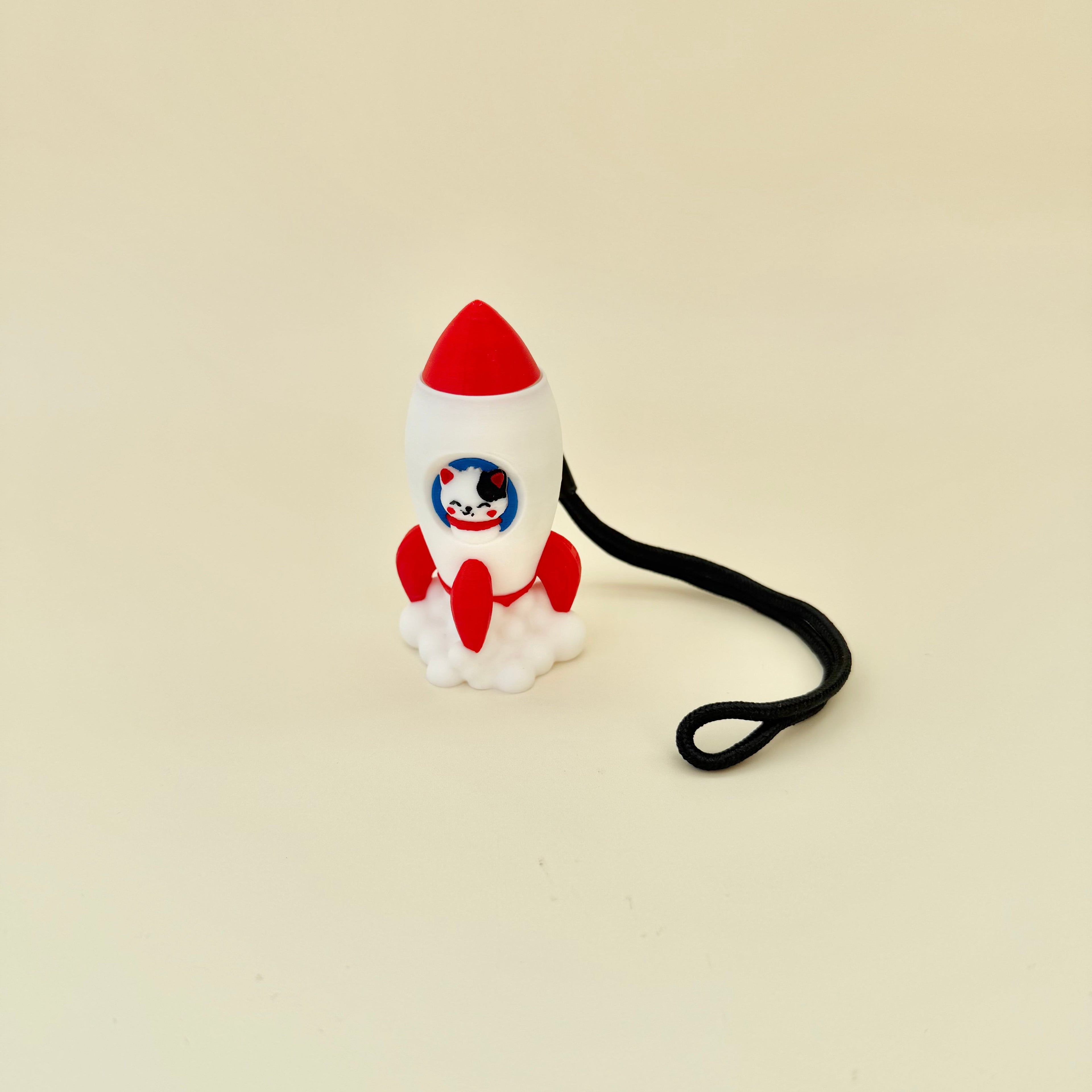 Cute astronaut-style cat clicker with wrist strap for bags, sensory kits and neurodivergent fidgeting.