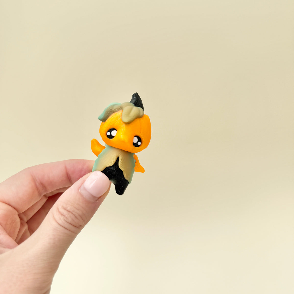 Pocket-sized articulated figure designed for gentle fidgeting and display.
