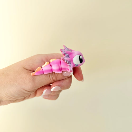 Articulated pink axolotl sensory fidget with shimmer accents