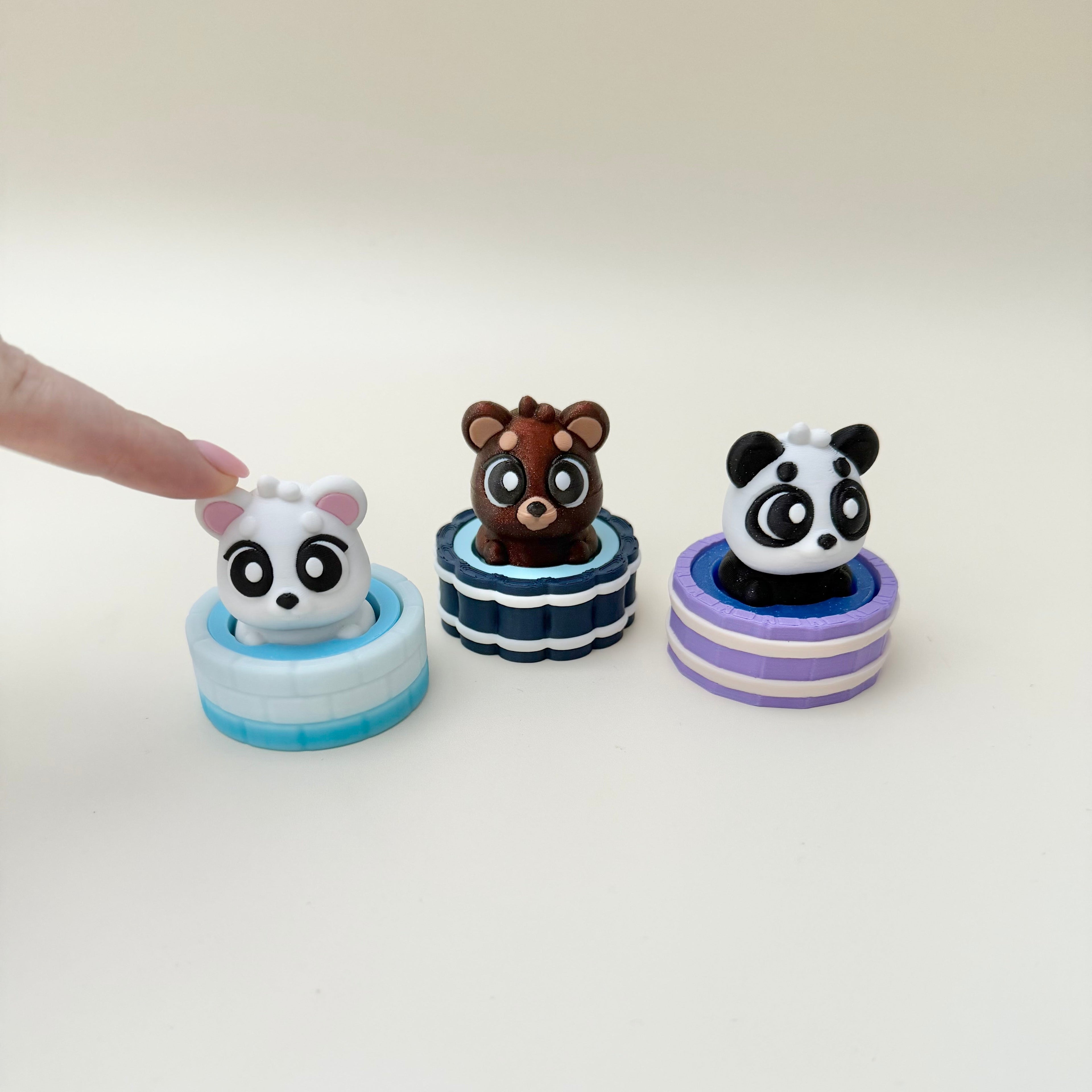 Small tactile clicker featuring a bear popping in and out of a bath, designed for calming fidget use.
