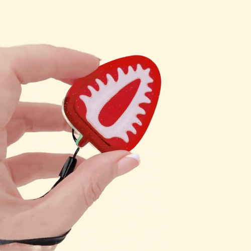 strawberry slice clicker fidget toy with glittery finish and tactile raised seeds
