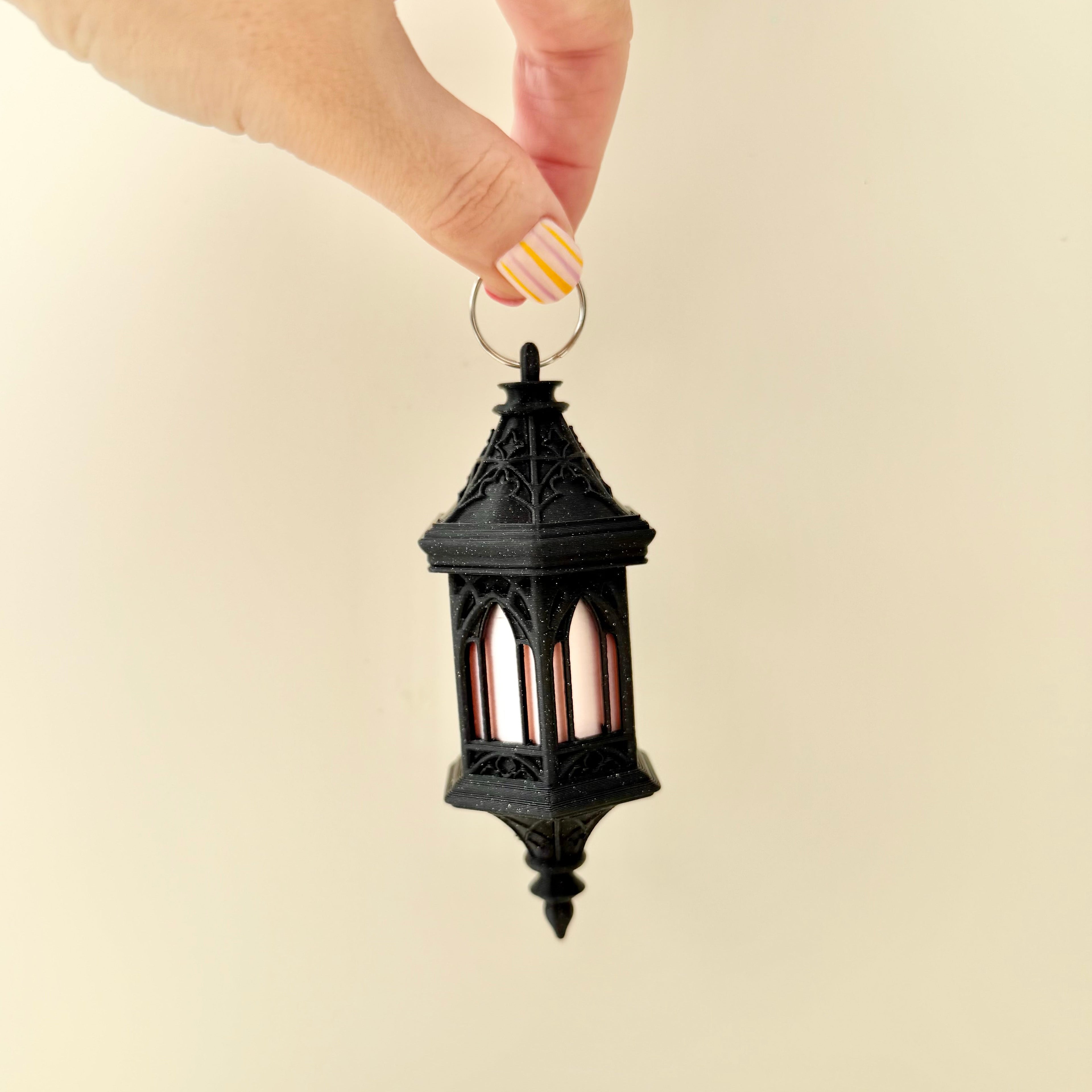 Decorative lantern keychain with subtle shimmer finish and tactile surfaces for calming input
