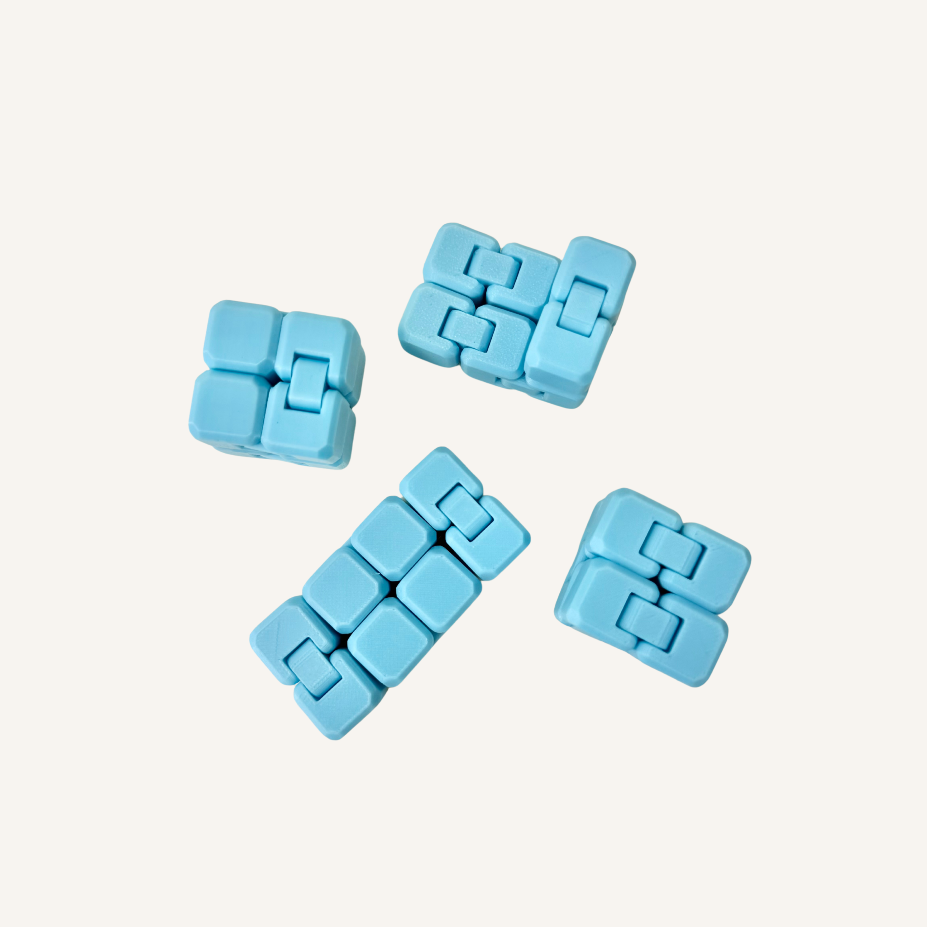 Pocket-sized blue glow in the dark infinity cube designed for smooth one-handed fidgeting.