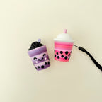 Handheld drink-style stim toy with a pop-in click mechanism and detailed design.