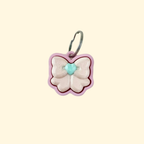small pink bow fidget clicker on keyring, 3 cm handheld sensory toy with press-down top
