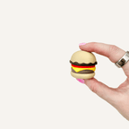 Burger sensory clicker with smooth rounded shape, pressable feedback and desk-friendly fidget use.