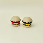 Small burger desk fidget with built-in clicker, smooth texture and repetitive press feedback.