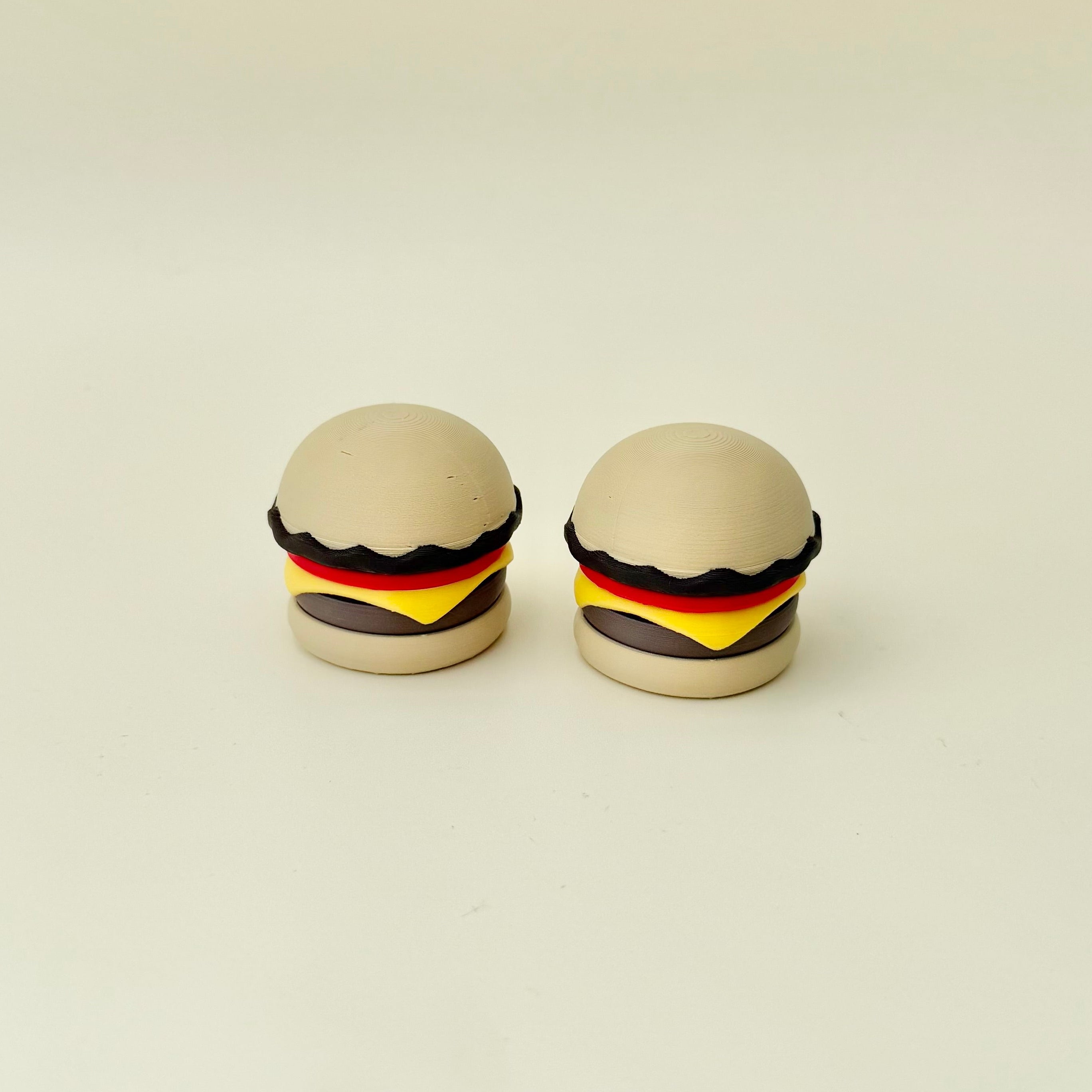 Small burger desk fidget with built-in clicker, smooth texture and repetitive press feedback.