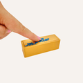 Gold butter bar sensory clicker with double press feedback, smooth finish and desk-friendly fidget use.