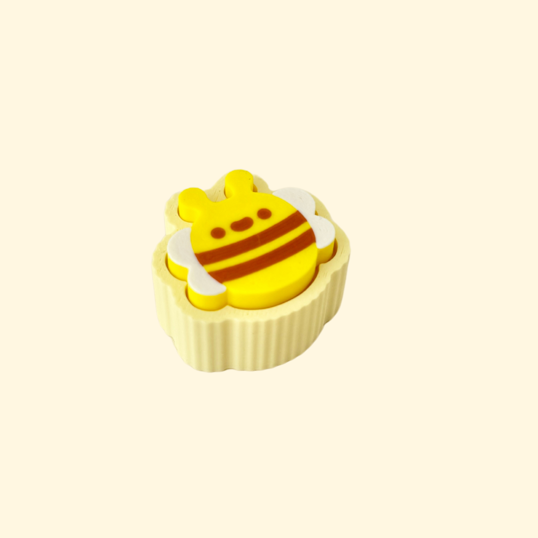 A cute bee fidget toy with a push-click mechanism for sensory play.