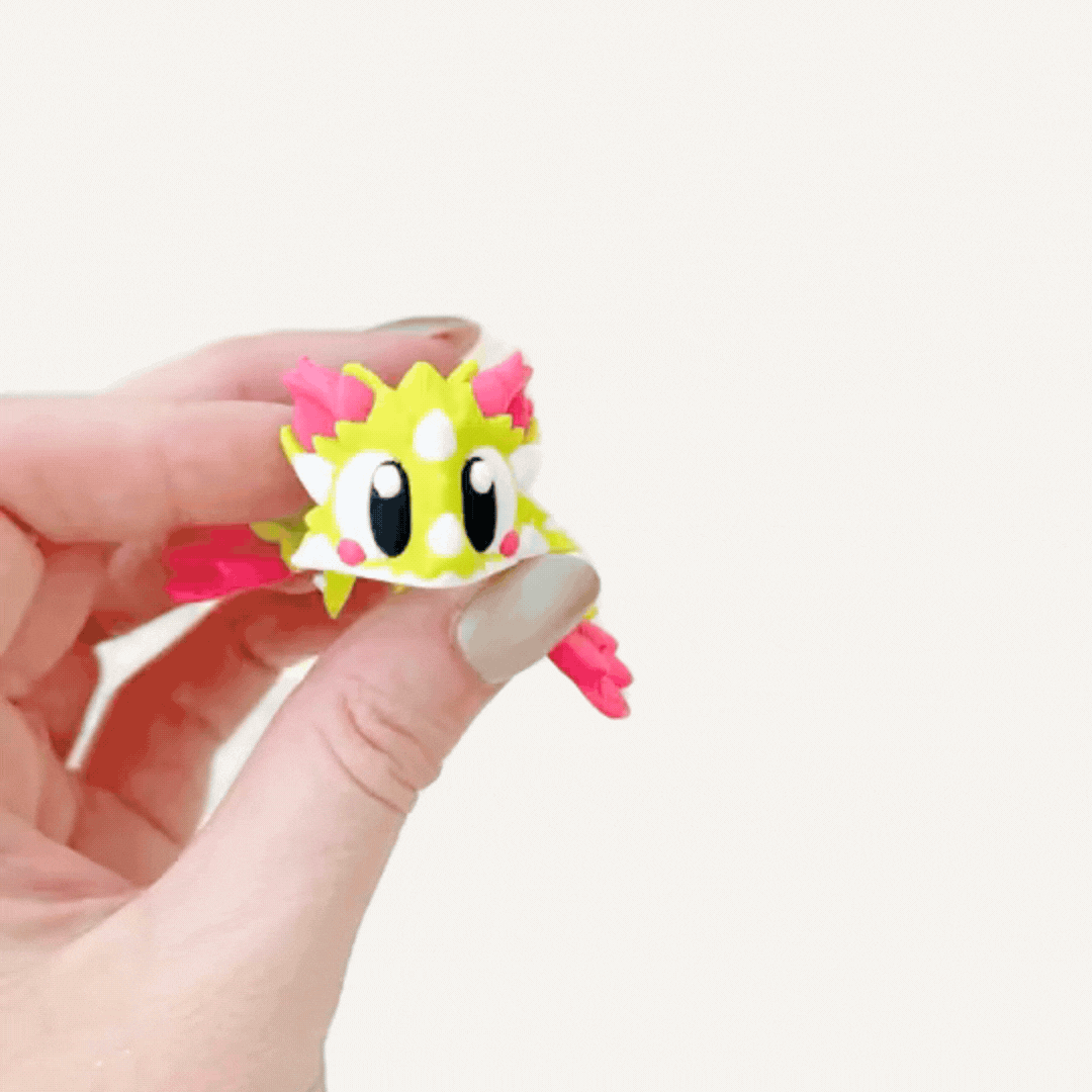Small articulated dragon fidget with raised texture and flexible body for busy hands and calming movement.
