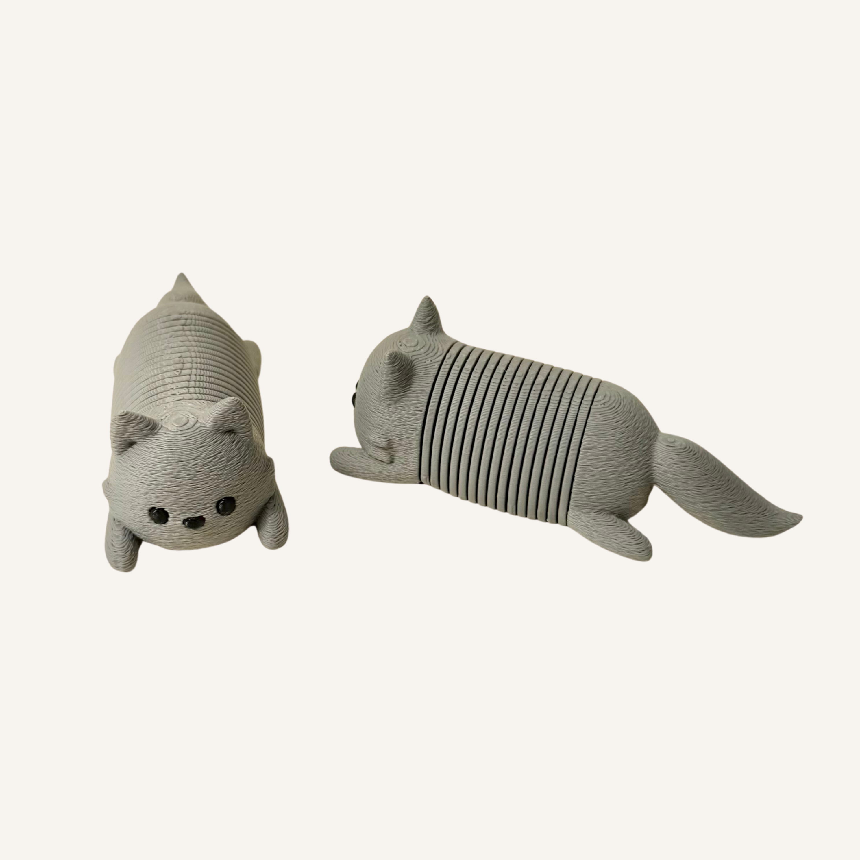 Grey spring cat fidget designed for gentle stretching and repetitive sensory movement.