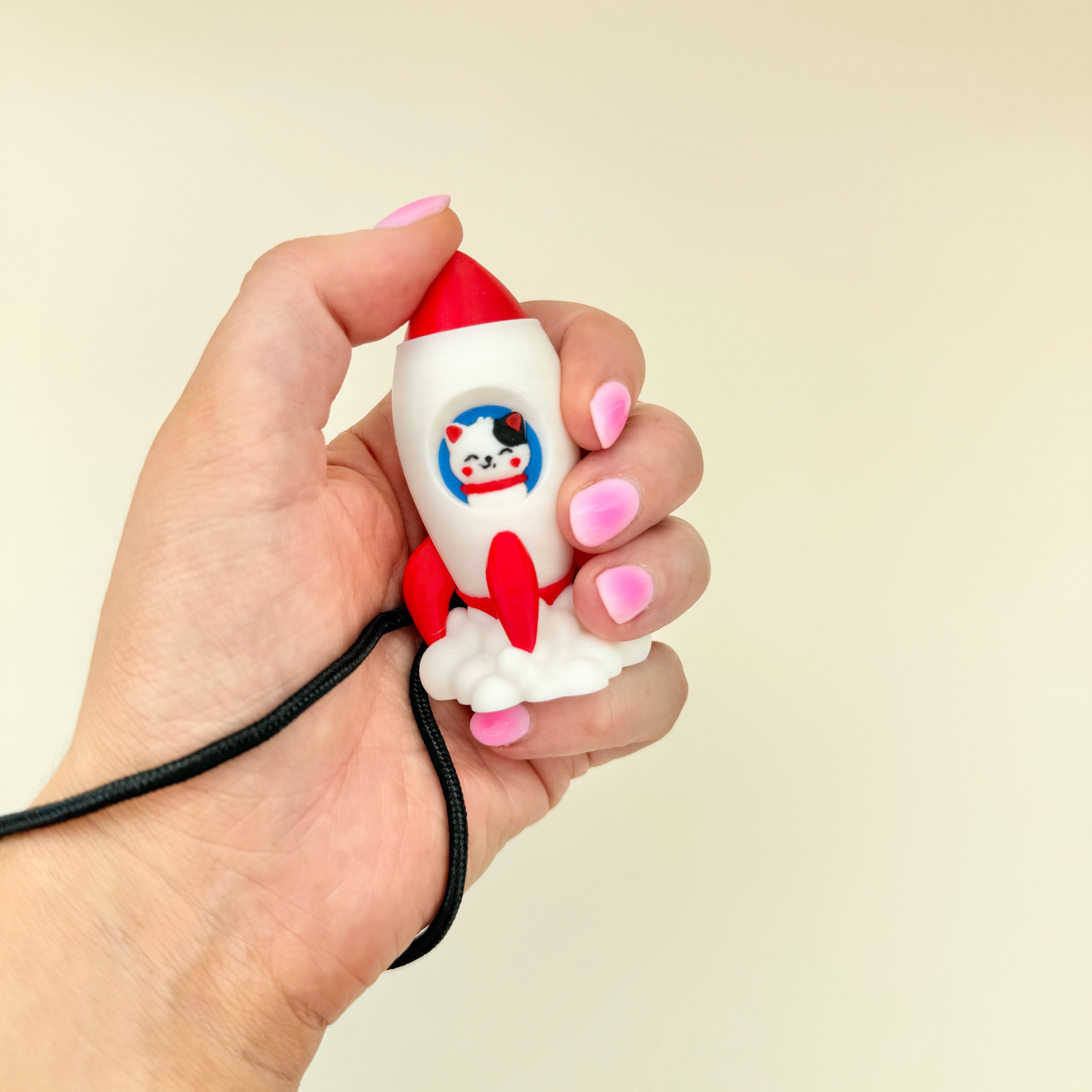 Portable cat rocket fidget with click or quiet click option for grounding and regulation.