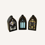 Small stained-glass inspired clicker charm with black sparkle frame and detailed gothic design for tactile everyday use.
