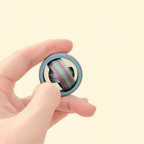 Mini 3.5cm diameter fidget spinner with a vibrant rainbow finish and full gyro spinner rings.