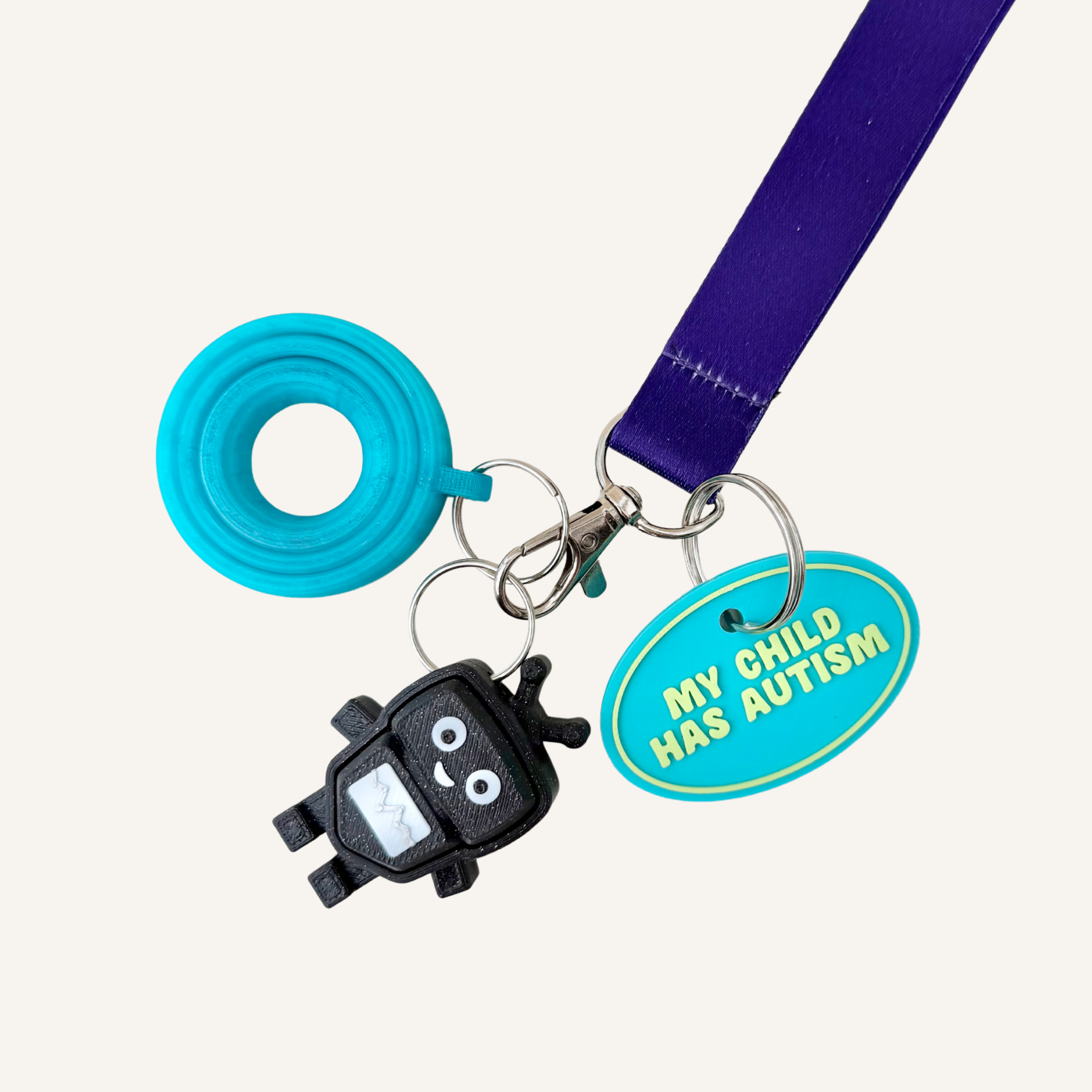 3D printed oval tag with raised text and silver loop for visible everyday child support.