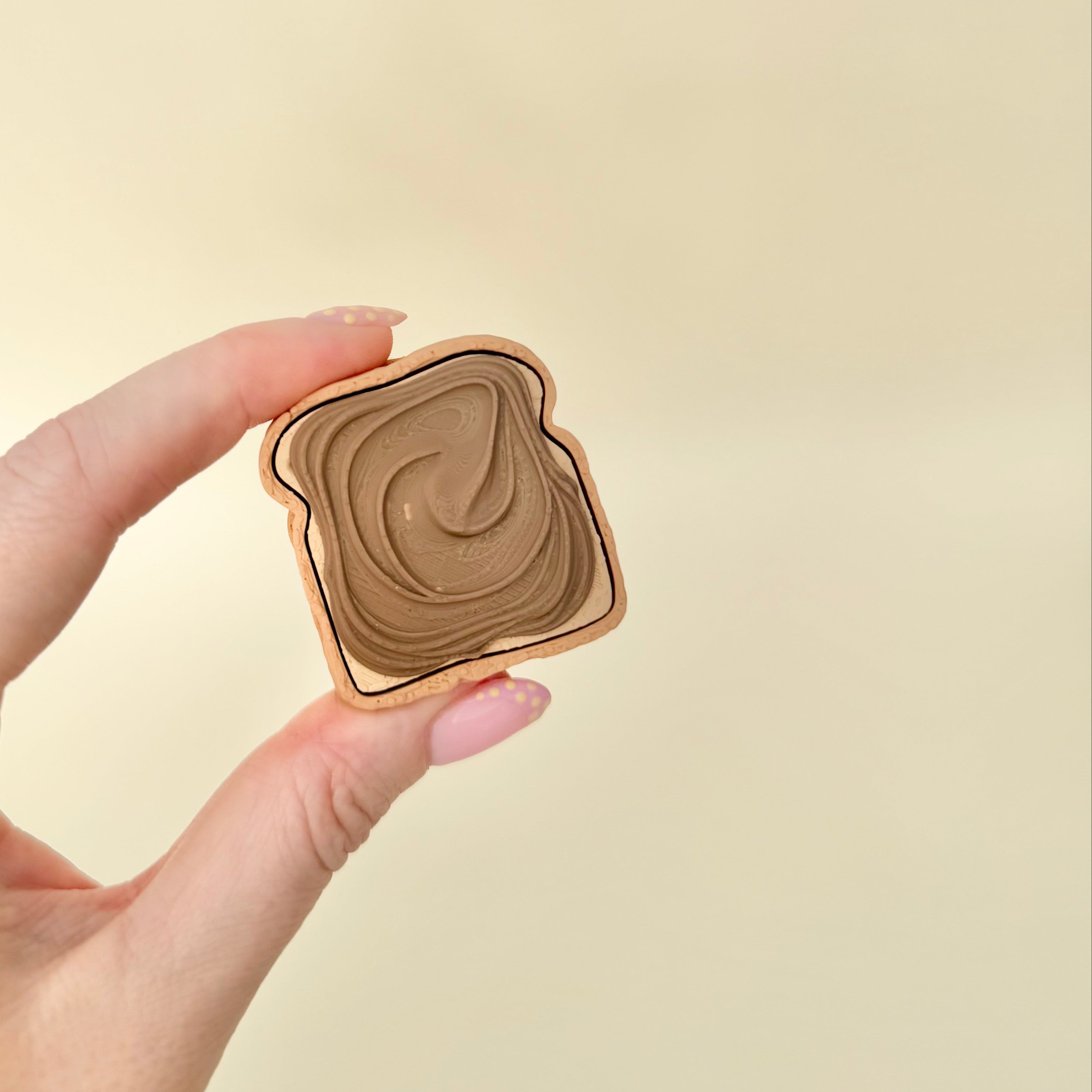 Novelty toast sensory clicker with a satisfying press and optional quiet click for discreet fidgeting.
