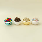 Palm-size clicker with raised chocolate cereal balls and smooth bowl finish.
