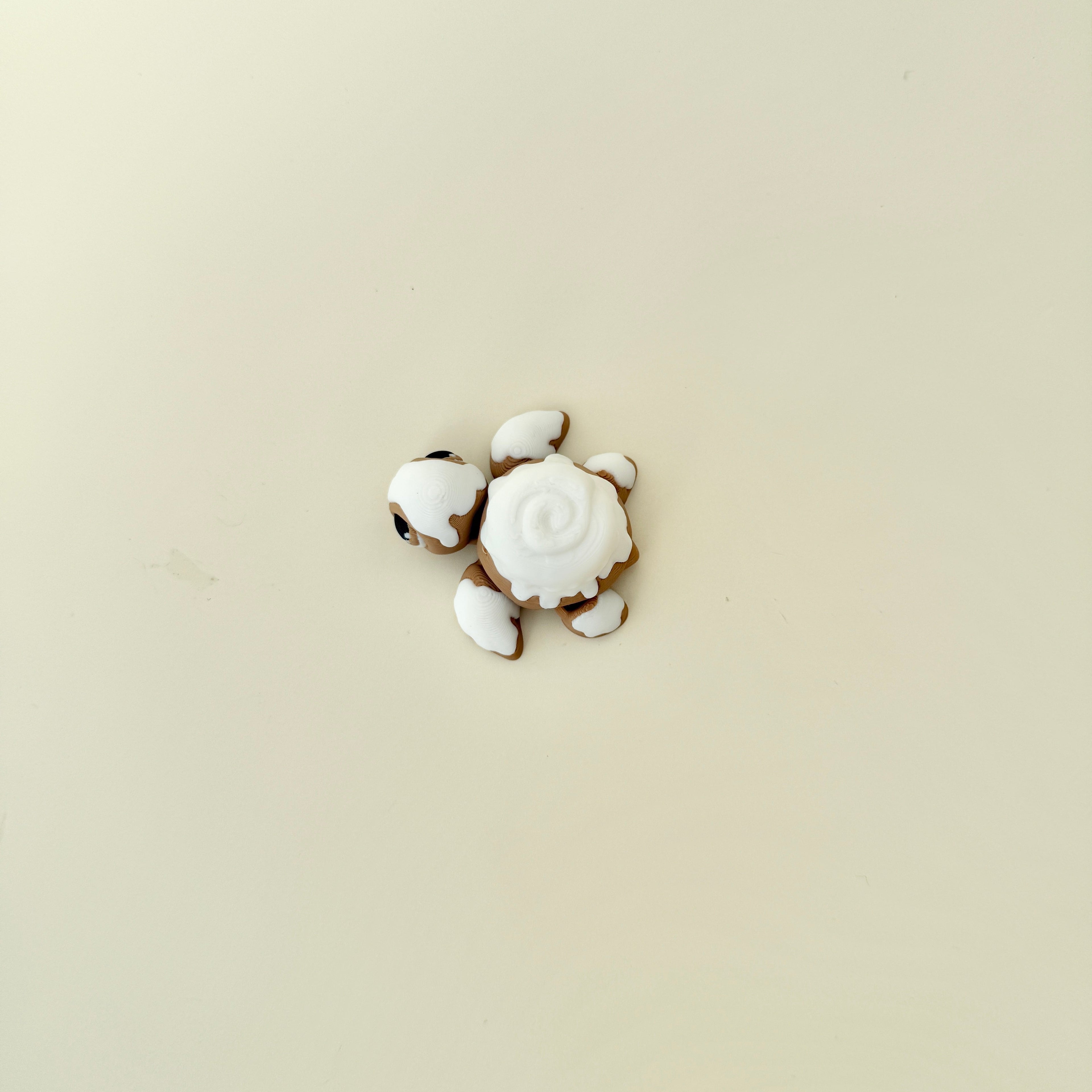 Handheld turtle fidget featuring mixed smooth and raised textures for sensory input.
