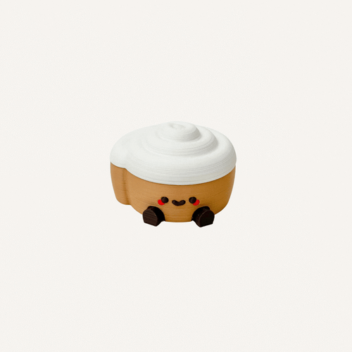 Cute mini cinnamon roll character with dangling legs designed for desks, shelves and cosy decor spaces
