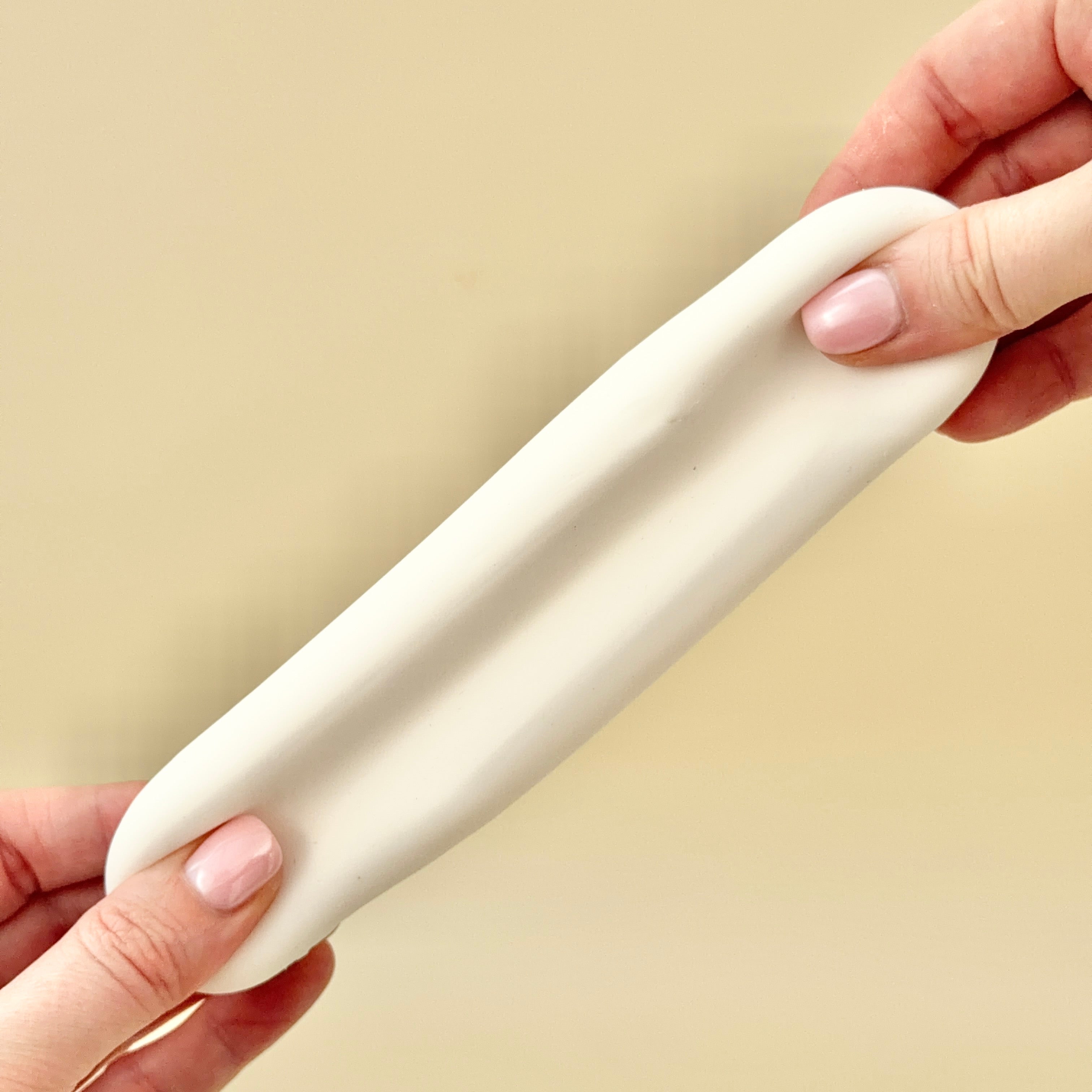 Minimalist squishy fidget toy with smooth finish and soothing gel squeeze for anxiety relief.