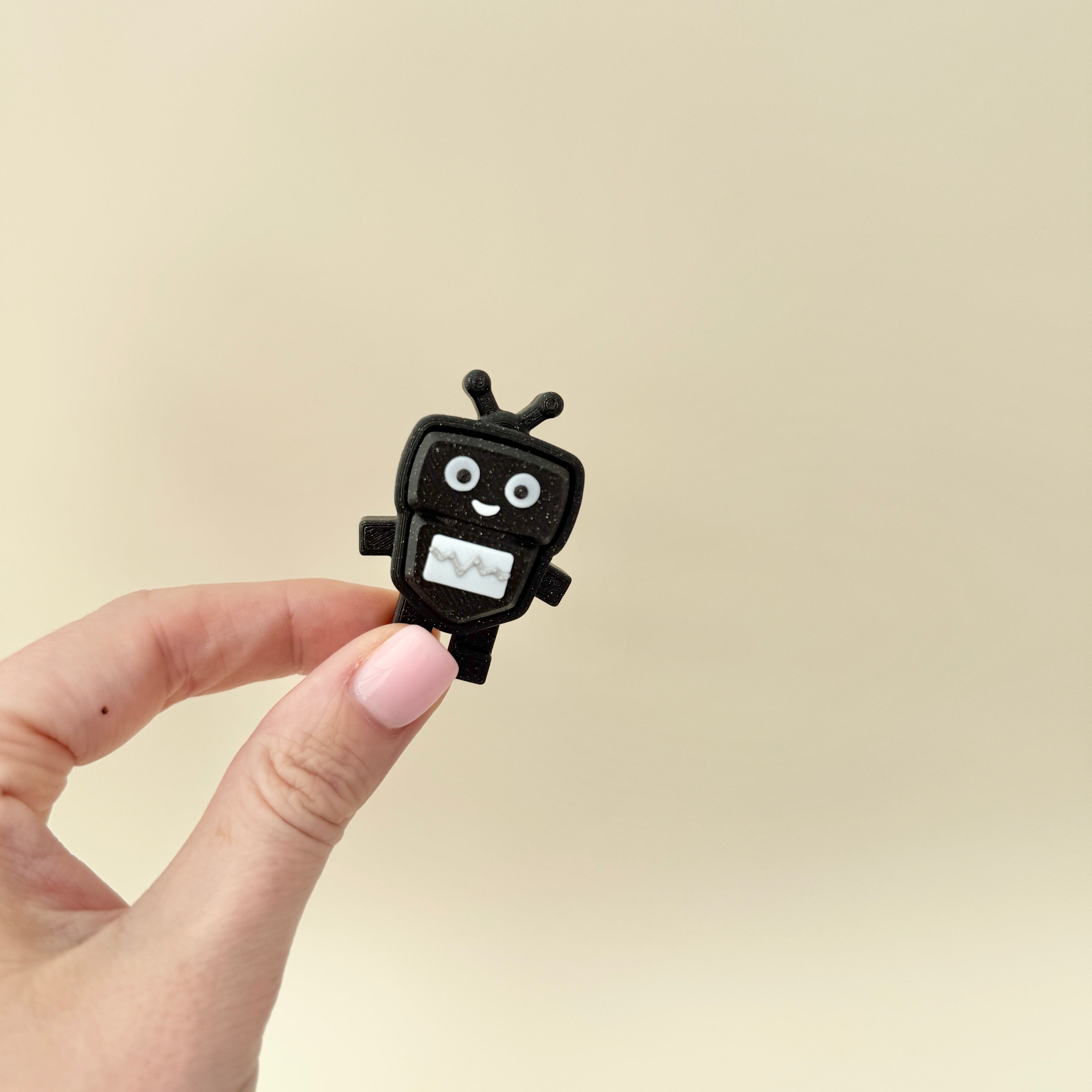 Black glitter keyring clicker with white panel; moderate click.
