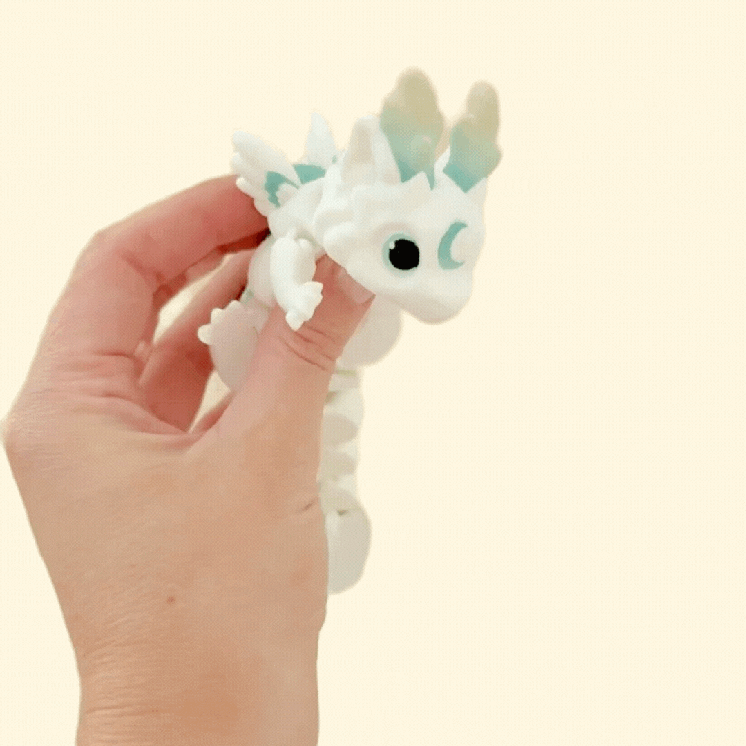 Side view showing the dragon’s white body, muted tones and moon detail.