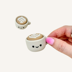 Cute coffee cup sensory clicker with pressable feedback, handle attachment and portable fidget use.