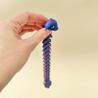 Cool-toned filament that changes hue with light and motion; low-noise fidget toy.
