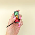 Small emotion communication clicker with happy, neutral and sad buttons for pointing, pressing and regulation.