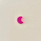Small crescent moon fidget toy with satisfying click motion in pink hues.