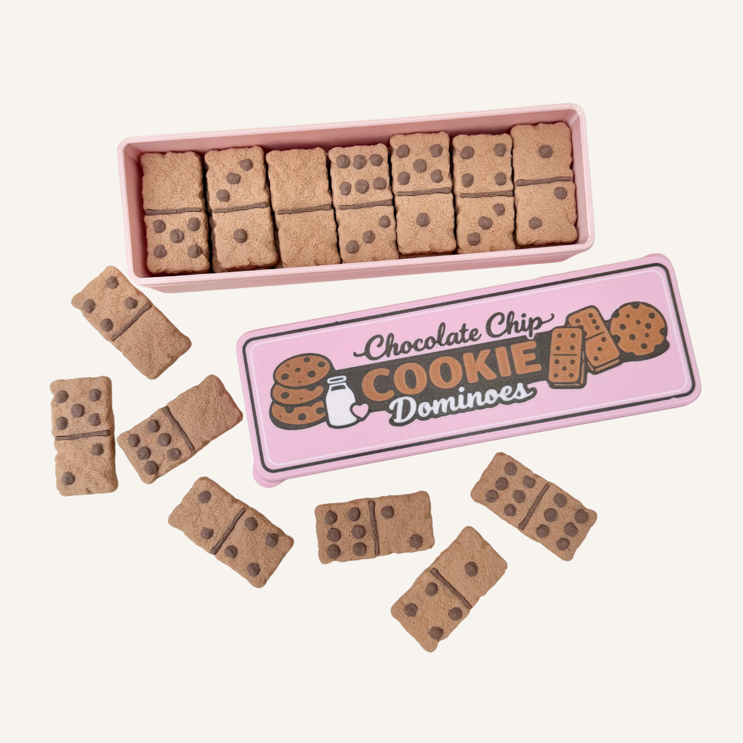 Tactile cookie-style domino tiles with raised chocolate chip bumps in a portable travel tin.

