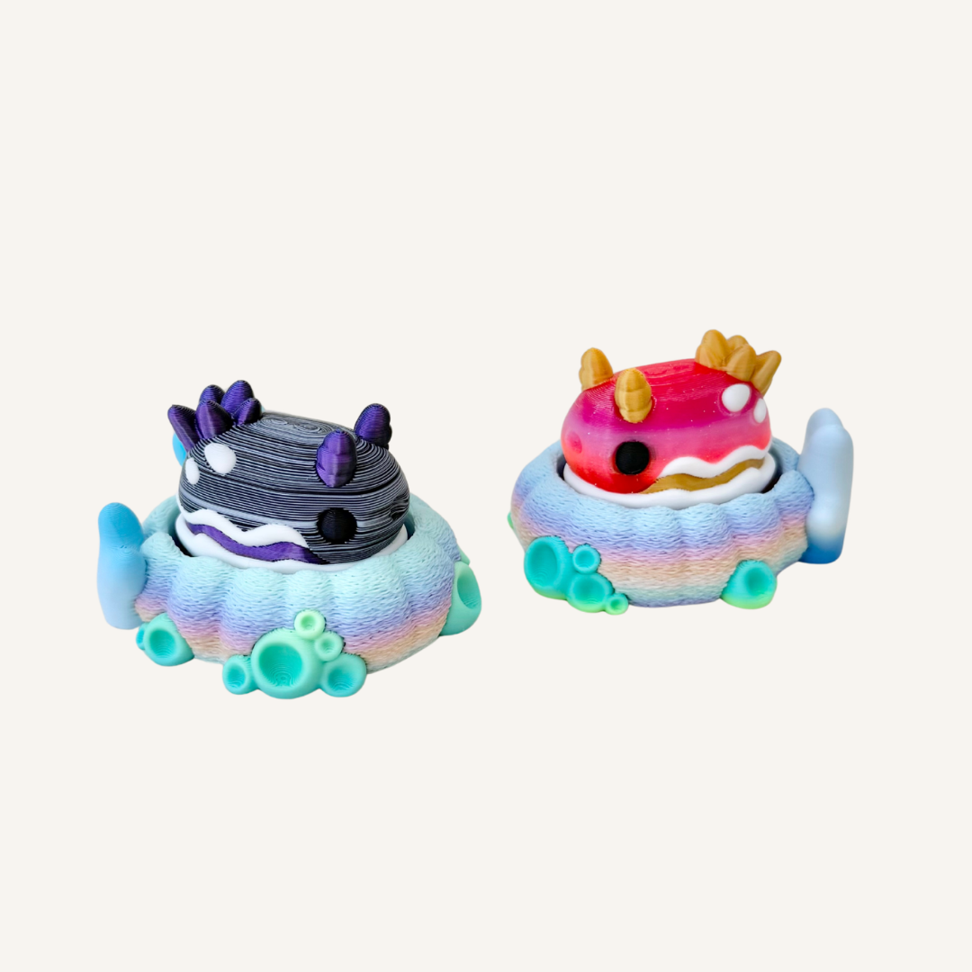 Cute sea creature fidget on a colourful coral base with tactile detail and collectible desk-friendly size.
