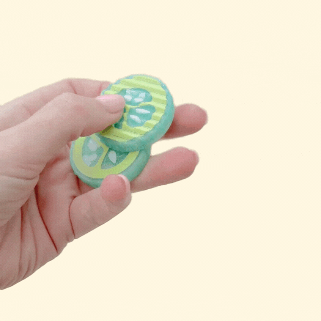 Magnetic pickle slice fidget with crinkle-cut ridges and bumpy texture for intense tactile input.
