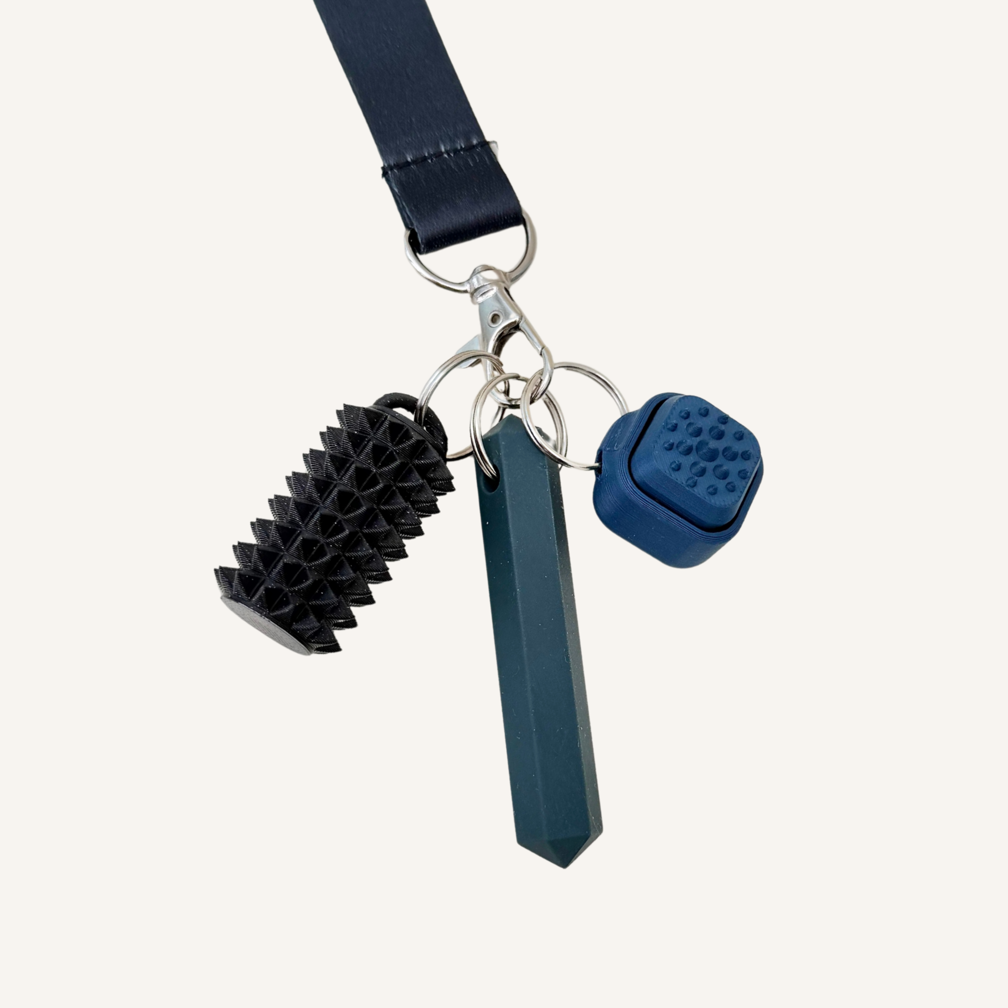 Silicone chew stim with an angular prism shape for light oral sensory input and portable daily use.
