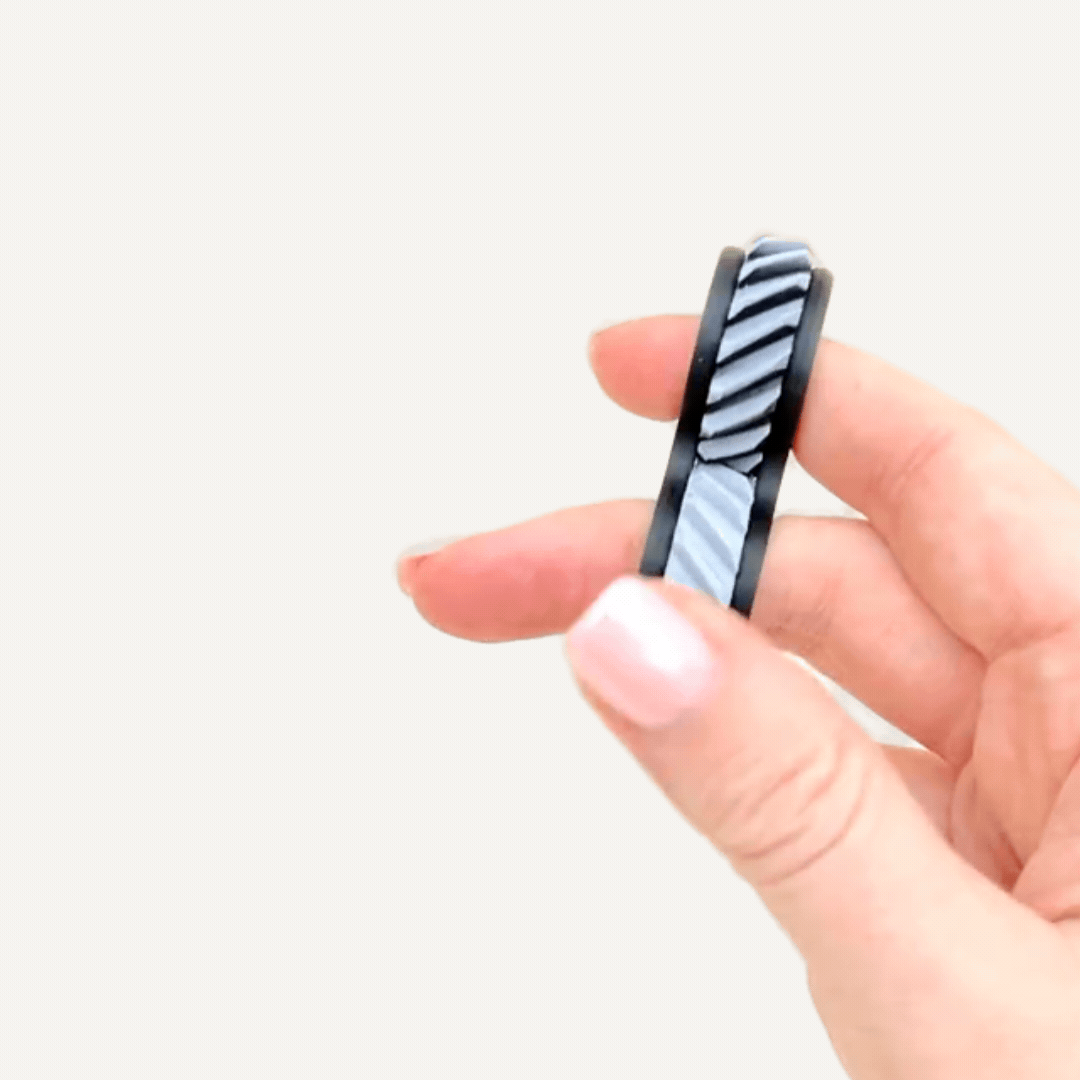Pocket-sized tactile fidget with custom colour options, smooth rolling movement and quiet sensory feedback.