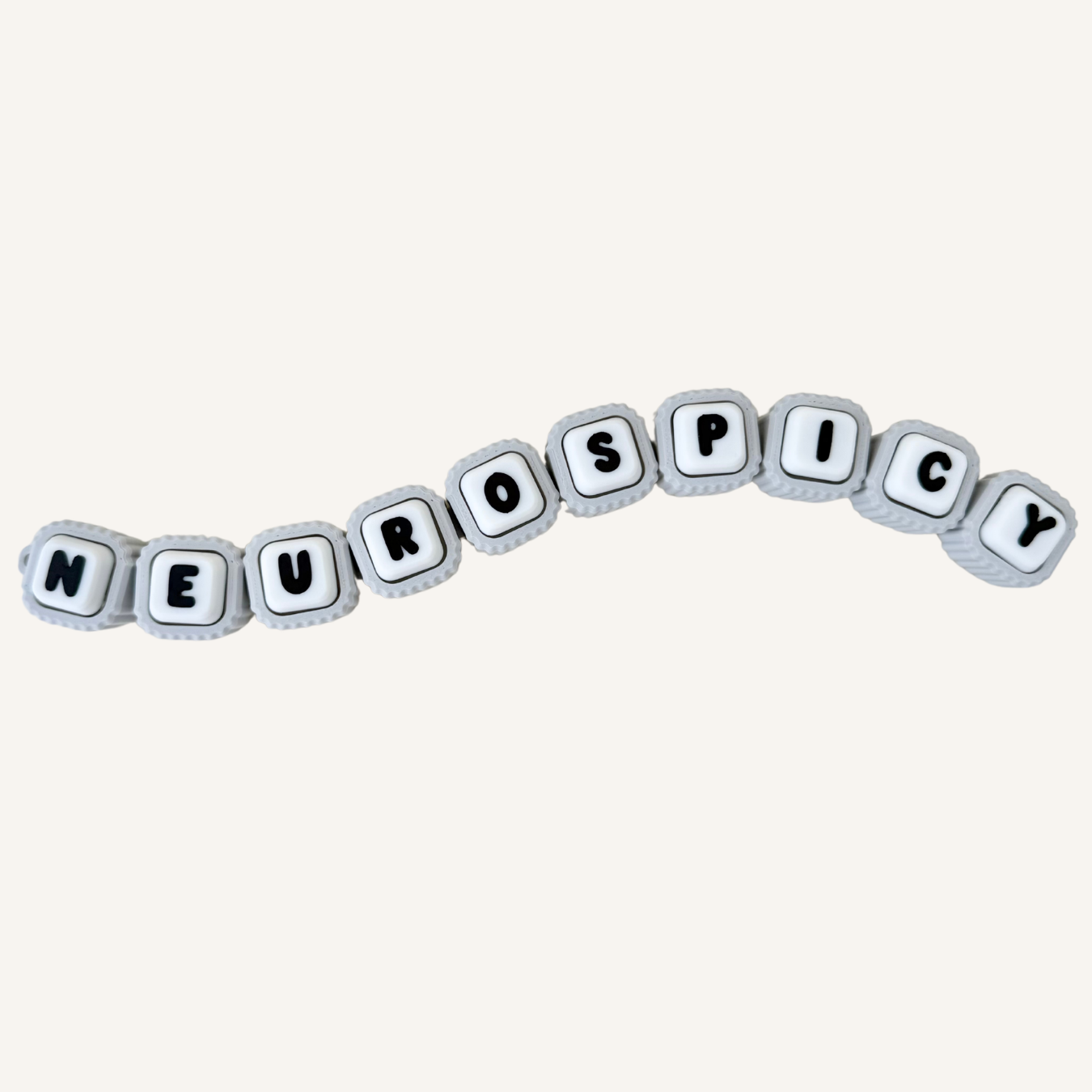 Buildable letter clicker fidget with individual pressable buttons, textured edges and sensory feedback for busy hands.