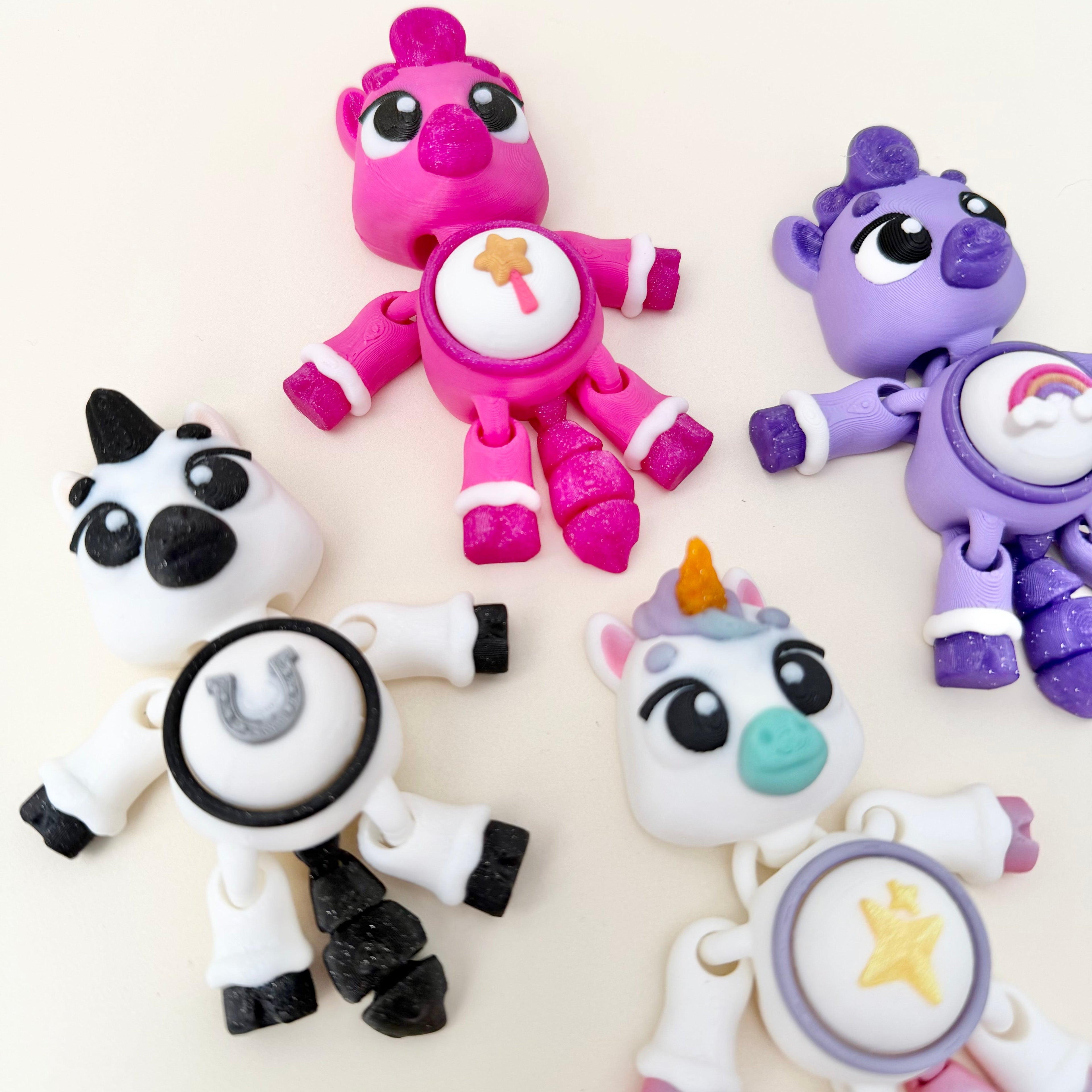 Handheld animal-shaped clicker fidget with flexible body and interchangeable button icon options.
