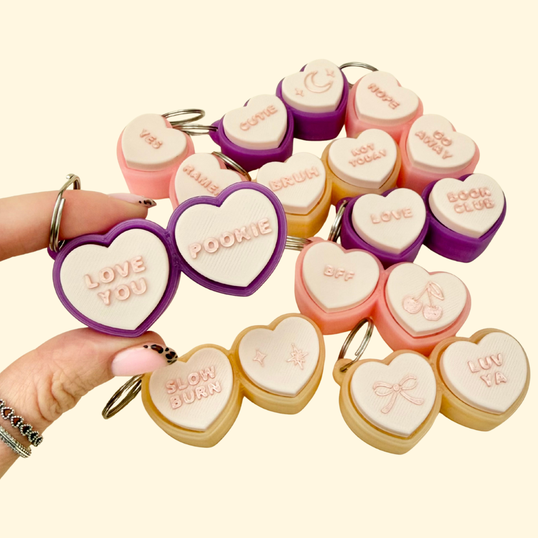 Two-button heart-shaped clicker fidget with keyring loop
