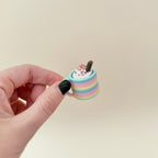 Mug-shaped sensory fidget with whipped top; choose colour, topping and click or quiet; portable desk-friendly size.
