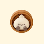 Press-down clicker fidget with a smiley dumpling topper and tactile base for grounding and stimming.

