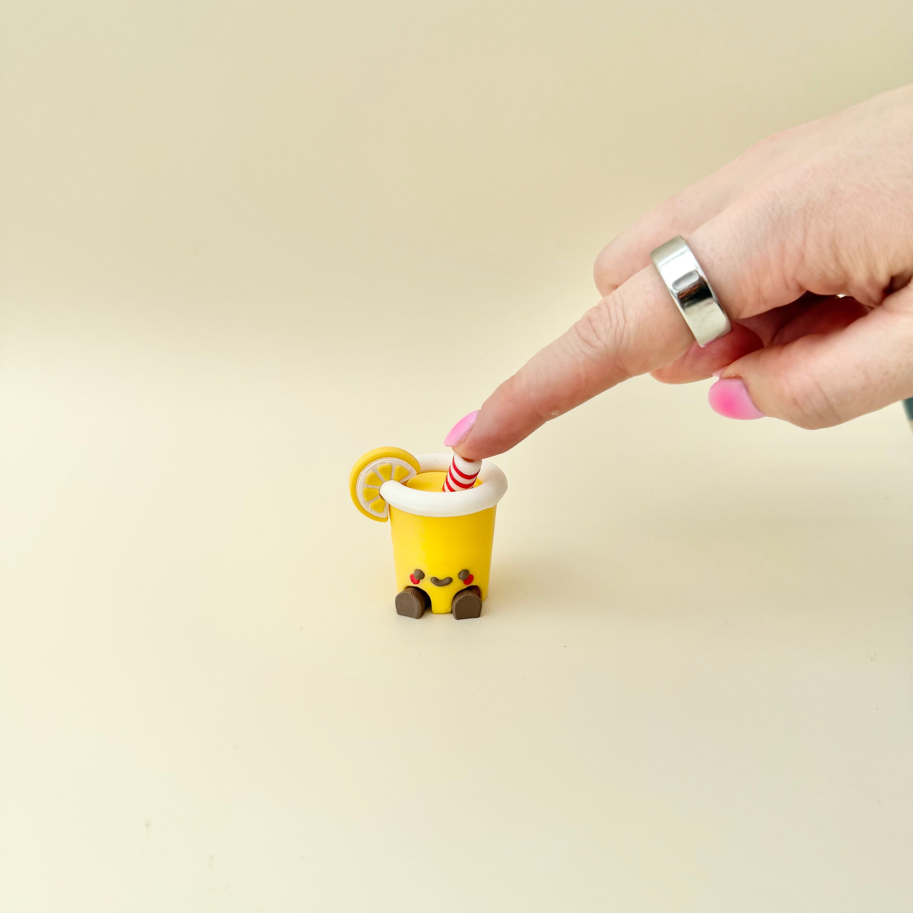 Lemon cup fidget with pressable clicker for grounding, sensory regulation and repetitive hand movement.