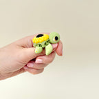 Small fidget turtle with a sunflower shell and moveable limbs, designed for tactile stimming and gifting.