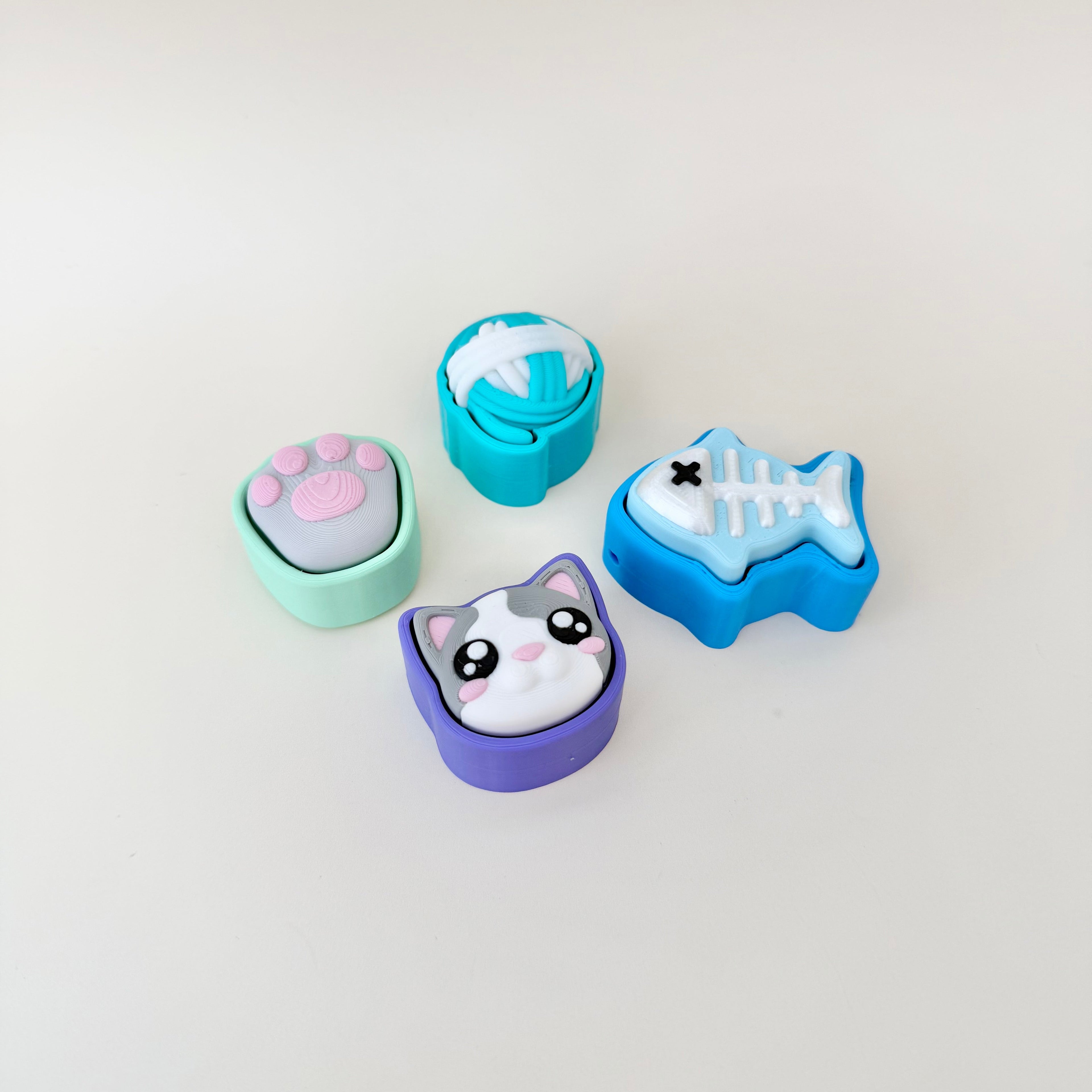 Mini cat clickers designed for tactile play, gifting and portable sensory support.

